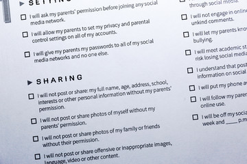 Fototapeta premium Parent-Child Social Media Contract. Contract regulating using social media by teen. Contract signing - between parents and their children on using social media.