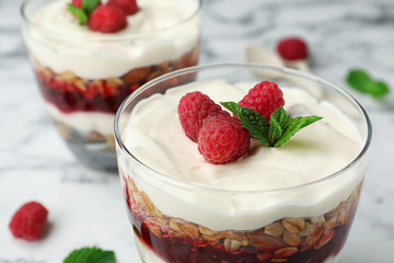 Delicious oatmeal dessert with raspberries in glass, closeup