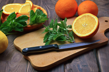 Fresh fruits and fragrant mint leaves, lemon balm. Healthy eating. Close-up. Concept. Orange.