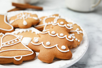 Plate with tasty homemade Christmas cookies on table, closeup