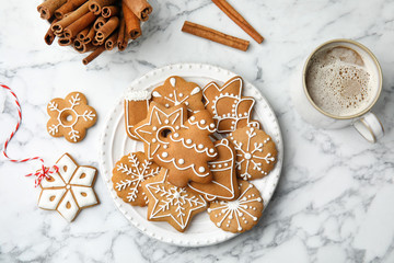 Plate with tasty homemade Christmas cookies and cup of coffee on table, top view - Powered by Adobe