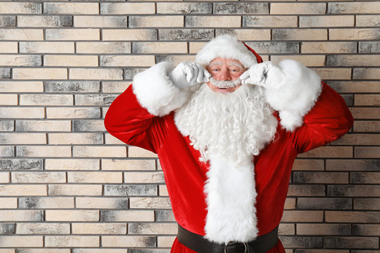 Authentic Santa Claus on brick wall background