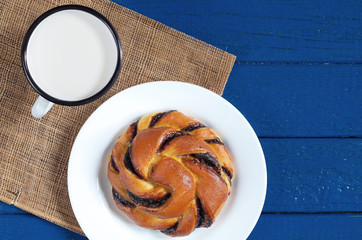 Mug of milk and sweet bun