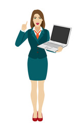 Businesswoman holding a laptop notebook and pointing up
