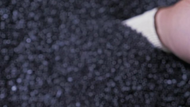 Plastic black gray granulated crumb. Manufacture of plastic water pipes of the factory. Process of making plastic tubes on the machine tool with the use of water and air pressure.