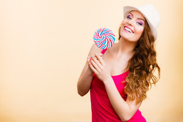 Woman holds colorful lollipop candy in hand