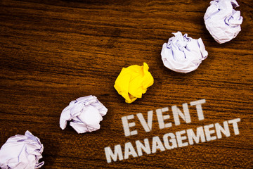 Text sign showing Event Management. Conceptual photo Special Occasion Schedule Organization Arrange Activities Ideas concepts words on wooden background crumpled papers several tries.