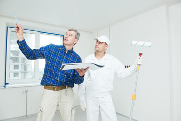 foreman designer and painter worker discussing painting project tas