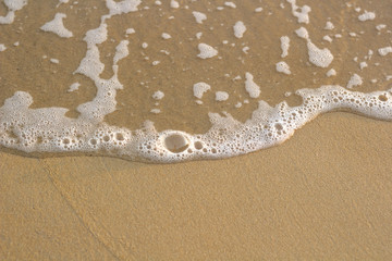 Soft wave of blue ocean on sandy beach. Background.