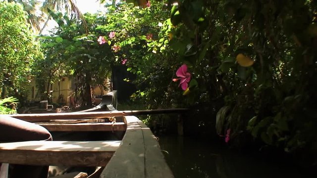 Sailing in a boat by Shacks in Kollam, India