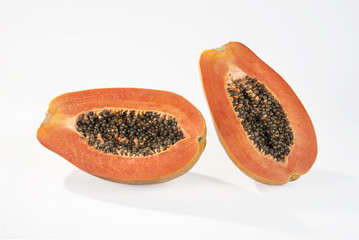 Papaya sliced in a halves isolated on white background