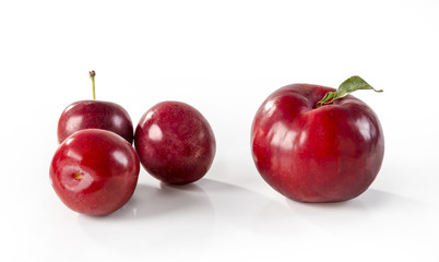 Cherries and  red plum over white background
