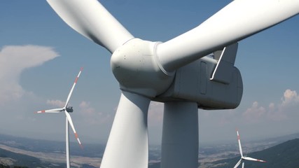 Aerial view of one windmill close to the turbine, blue sky in the background