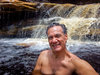 Middle Aged Man Enjoying Himself at a Waterfall in the Northeast Brazil in the State Bahia 