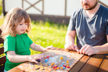 Moscow, june 18 2018. Father and his cute little girl playing strategy board game