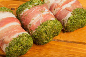 Semi-finished meat, seasoned on a wooden background.