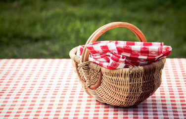 picnic basket on table in the garden - summertime