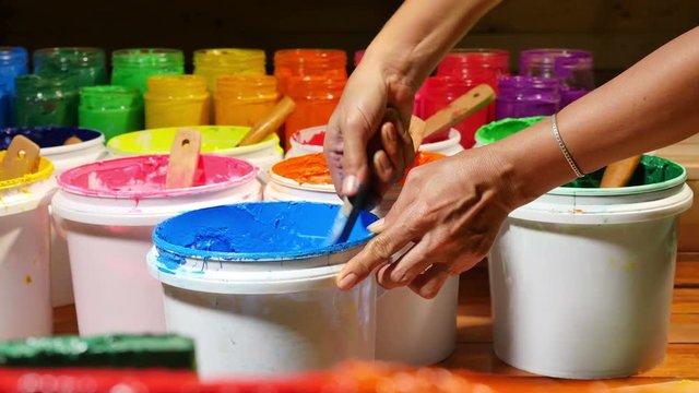 stir and scoop paint in white barrel be for print on tee shirt. plastisol ink useful in tee shirt factory also to print on the other fabric