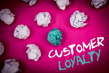 Text sign showing Customer Loyalty. Conceptual photo Client Satisfaction Long-Term relation Confidence Ideas white blue letters pink background crumpled papers several tries.