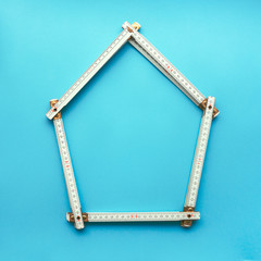 Wood carpenter folding ruler in shape of a house