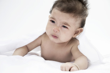 baby crying on the bed