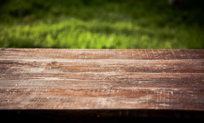 wooden picnic tabletop in the garden - summertime background with copy space