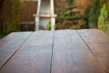 Fototapeta premium wooden picnic tabletop in the garden - summertime background with copy space