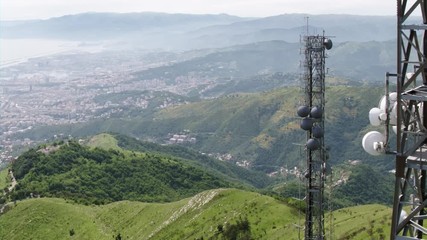 aerial view of telecom antennas telecommunications towers with cityscape in the background
