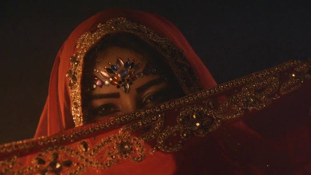 Belly dancer slow motion, warm oriental mood with smoke
