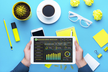Workplace with office tools and gadgets. Cup of coffee on a table. Tablet, laptop, phone and camera to develop applications or other projects. White, black and yellow background. Flat layer photo. © Cressida studio