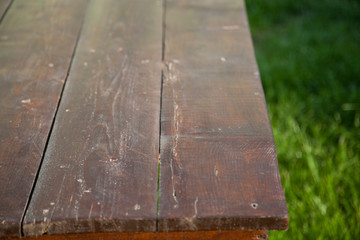 wooden picnic tabletop in the garden - summertime background with copy space