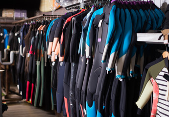 Image of colorful wetsuit hanging in the  store for surfing
