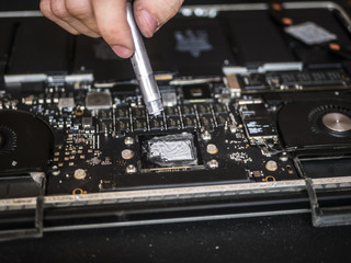 Fototapeta na wymiar engineer applying thermal paste on the computer board chip hardware cpu