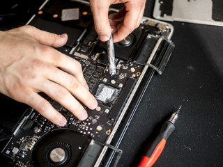close up hands with thermal paste apply it to laptop cooler system