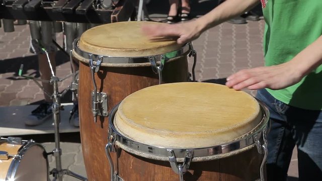 The street drummer plays the Conga drums