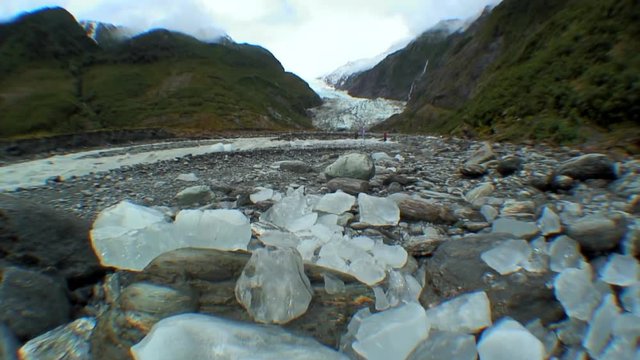 Chunks of Glacial Ice with a Glacier in the Background