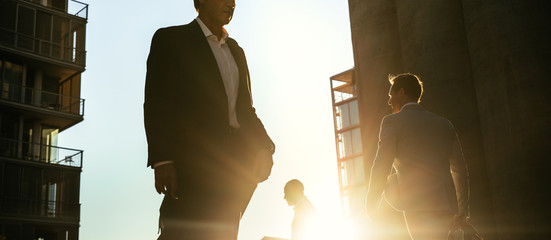 Business people walking on a busy street to office early in the