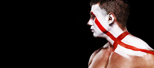 Soccer or football fan with bodyart on face with agression - flag of England.