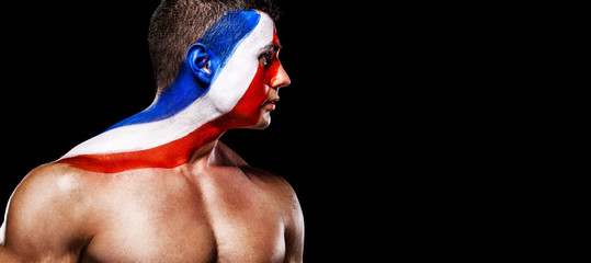 Fototapeta premium Soccer or football fan with bodyart on face with agression - flag of France.