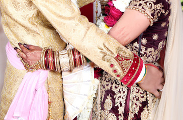 Indian bride and groom pose for beautiful portraits after their colorful jaimala ceremony ( garlands ceremony )