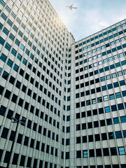 Fototapeta premium Plane flying over building