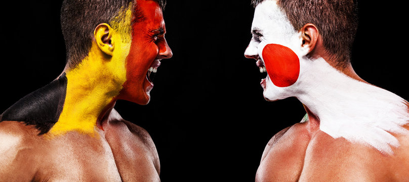 Soccer or football fan with bodyart on face with agression - flag of Belgium vs Japan.