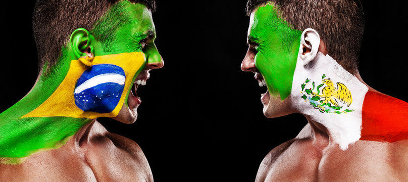 Soccer or football fan with bodyart on face with agression - flags of Brazil vs Mexico.