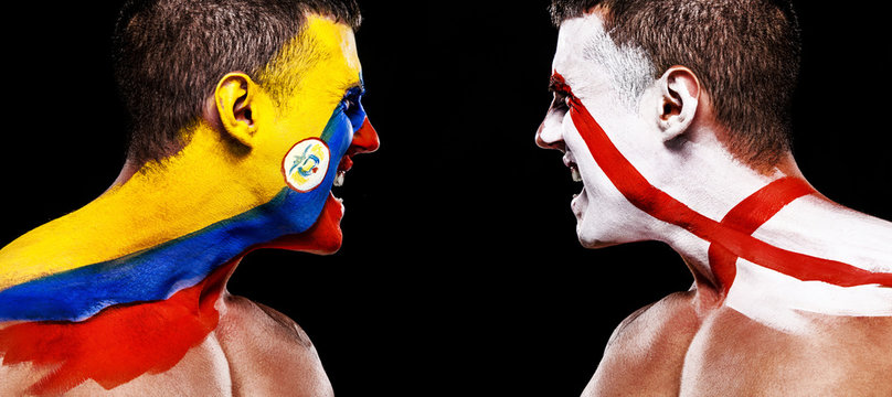 Soccer or football fan with bodyart on face with agression - flags of Colombia vs England.