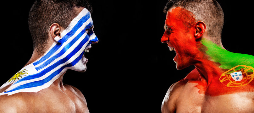 Soccer or football fan with bodyart on face with agression - flag of Uruguay vs Portugal.