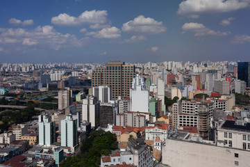 General cityscape with buildings as far as you can see under blue sky under blue sky