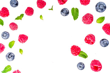 Creative layout with raspberry and blueberry with waffle ice cream cones, simple pattern above copy spaceries