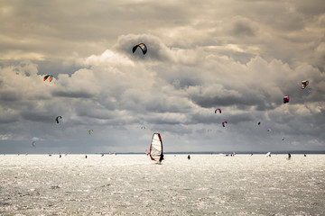 wind kiting and wind surfing on the ocean with wonderful clouds | Hel, Poland