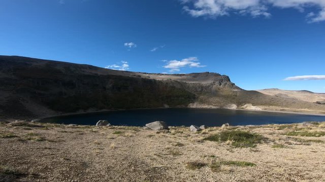 Stabilized camera movement going forward to a lagoon in Batea Mahuida volcanos crater at Villa Pehuenia, Moquehue, Neuquen, Patagonia Argentina. Big Mountain with steppe landscape.
