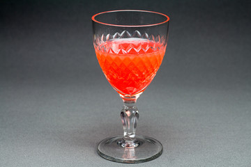 Crystal glass of red liquid